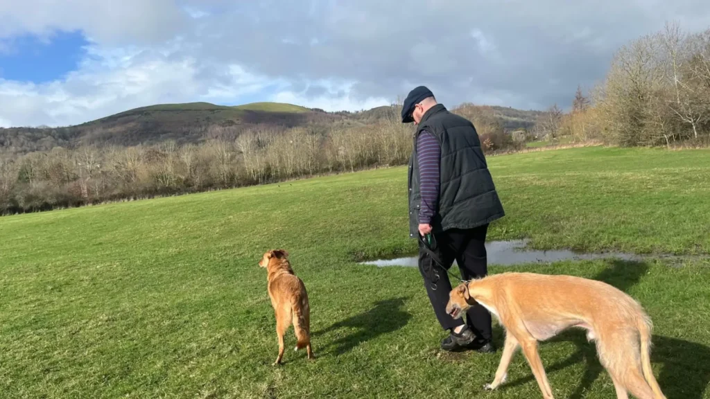 Stuart Callister, founder of Severn Vale Homecare, walking a dogs in Malvern